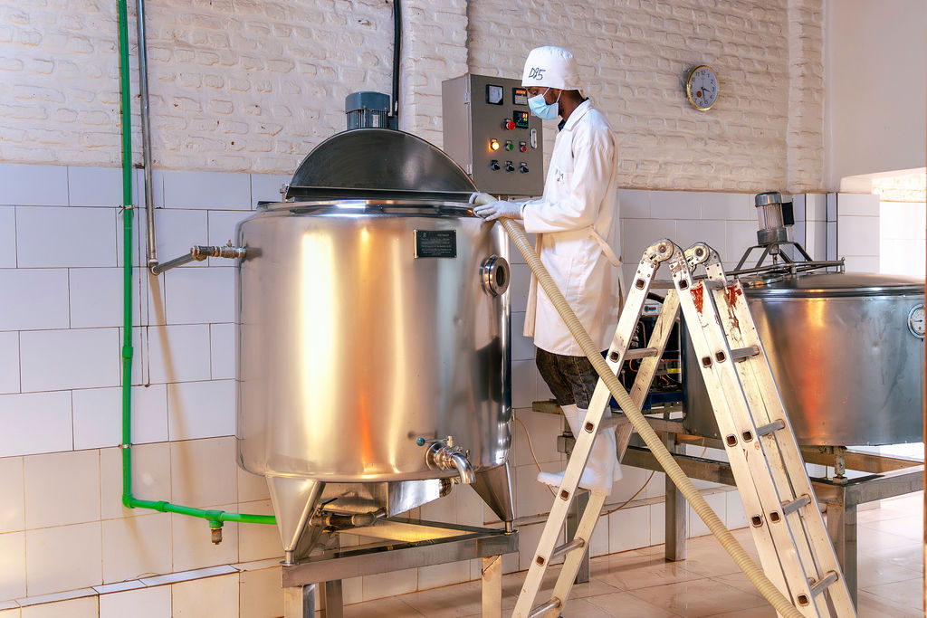 An Ishyo Foods worker tending a stainless-steel yoghurt production vat