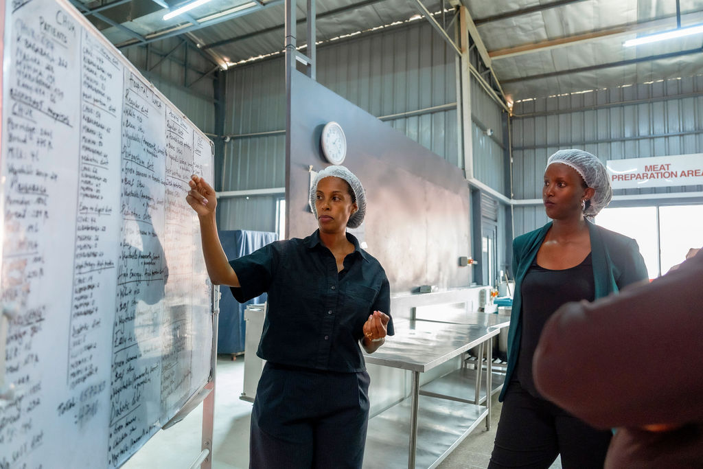 A cook reads the day’s menu board in the industrial feeding-programme kitchen