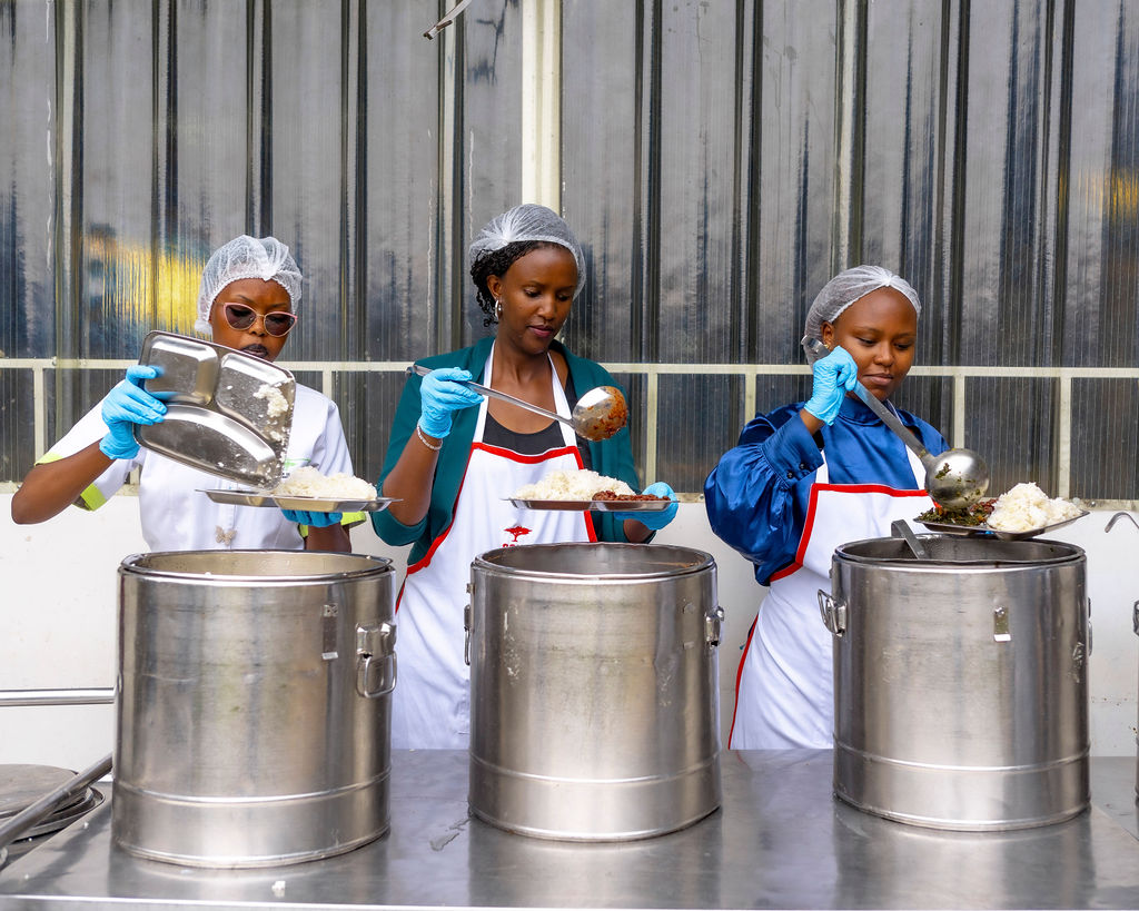 An Ishyo Foods worker holding a finished yoghurt cup during quality checks